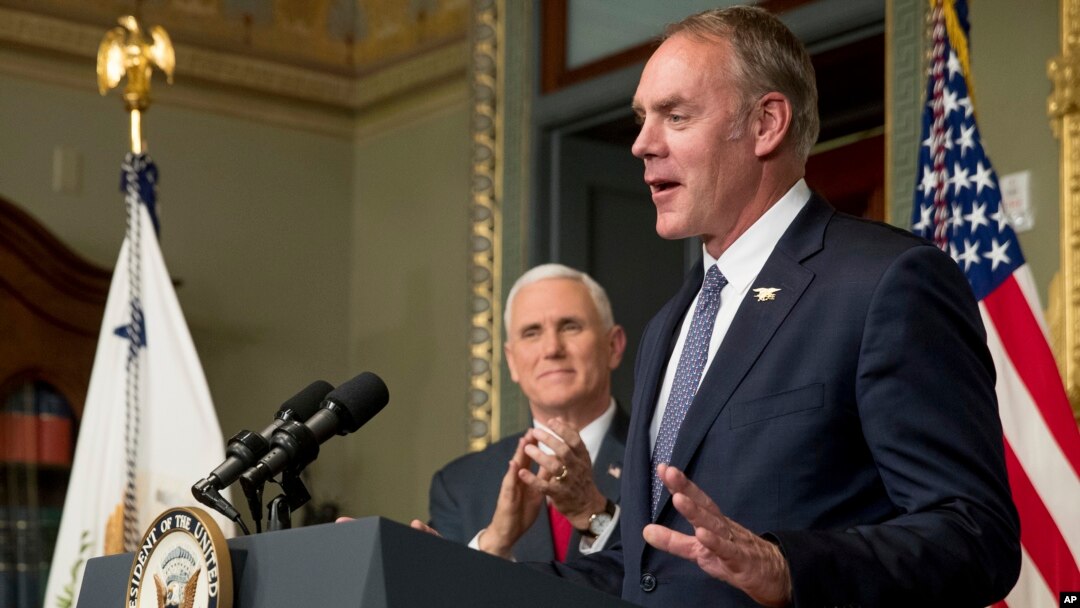 Vice President Mike Pence applauds as newly sworn in Interior Secretary Ryan Zinke addresses the crowd, March 1, 2017, in the Eisenhower Executive Office Building in Washington.