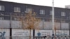 Two layers of barbed wire fencing ring the "Hotan City apparel employment training base" where Hetian Taida has a factory in Hotan in western China's Xinjiang region, Wednesday, Dec. 5, 2018. 