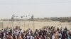 People gather and wait to welcome their relatives arriving from Afghanistan, at the Friendship Gate crossing point at the Pakistan-Afghanistan border town of Chaman, Pakistan, Aug. 17, 2021.