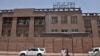 FILE - Afghan men walk past Da Afghanistan Bank in Kabul on June 28, 2011. 