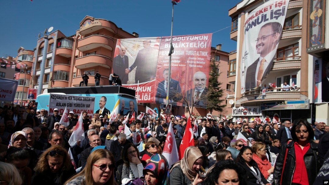 People listen to Mehmet Ozhaseki, the candidate of Turkey's ruling Justice and Development Party, AKP, and opposition Nationalist Movement Party, MHP, for Ankara Metropole, during a rally by MHP in Kecioren district, in Ankara, Turkey, Sunday, March 10, 2019. 