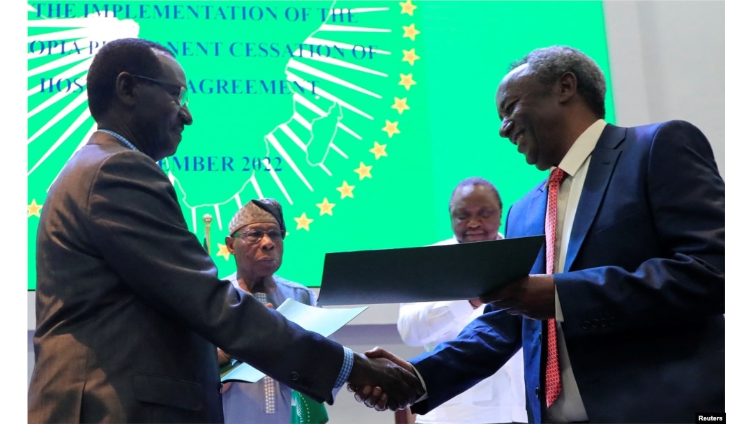 Field Marshal of the Ethiopian National Defence Force Birhanu Jula and Tadesse Werede Tesfay of the Tigray forces shake hands during the signing of the implementation of the cessation of hostilities, in Nairobi, Kenya, Nov. 12, 2022.