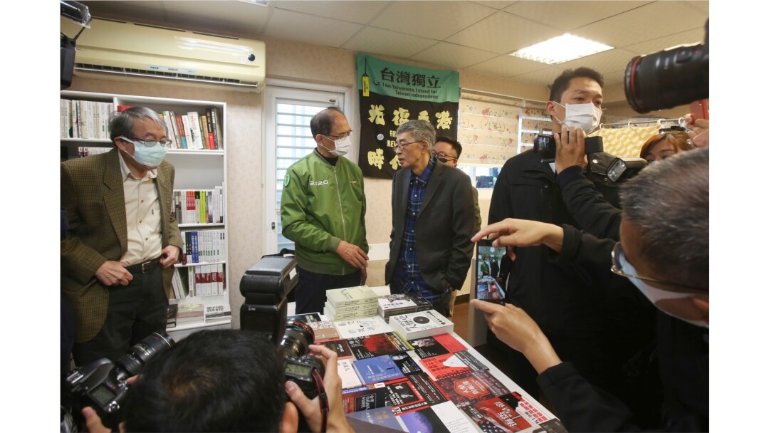 Lam Wing-kee, center right, is congratulated by Taiwan's Legislative Yuan Speaker Yu Shyi-kun, center left, on the opening day of his new book shop in Taipei, April 25, 2020.