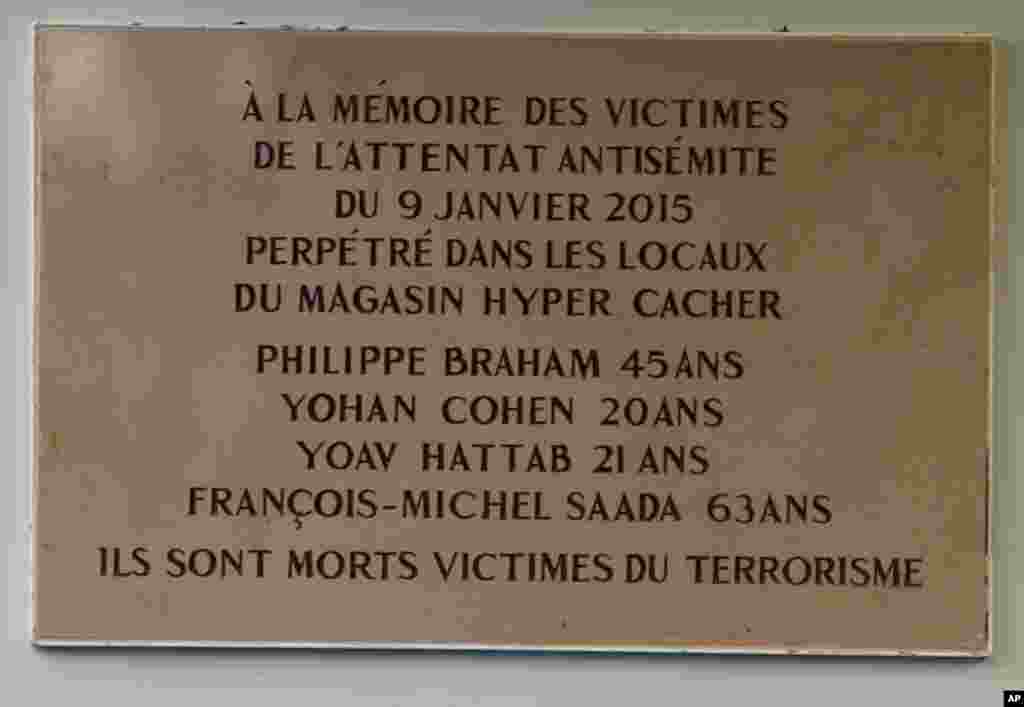 A plaque unveiled by President Francois Hollande pays tribute to the victims of last year's attacks outside a kosher supermarket.