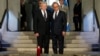 France's President Francois Hollande, right, stands with German President Joachim Gauck, left, as they pay respect in the crypt of the the National Monument of Hartmannswillerkop, in Wattwiller, eastern France, Aug. 3, 2014, to mark the 100th anniversary 