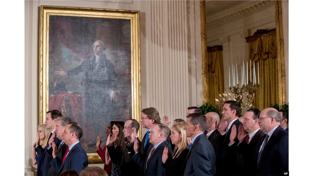 FILE - From left, President Donald Trump's advisors Kellyanne Conway, Jared Kushner, Steve Bannon, and Trump Chief of Staff Reince Priebus, and other members of White House senior staff are sworn in at the White House, in Washington, Jan. 22, 2017.