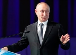 Russian President Vladimir Putin gestures as he delivers his speech during the International Forum "The development of parliamentarism" in Moscow, July 3, 2019.