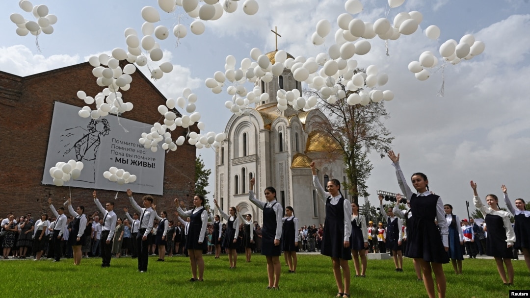 Children release white balloons outside the former school, which came under an attack by Islamist militants in 2004 and is currently a center of patriotic education and terrorism prevention, during a ceremony marking the 20th anniversary of the siege, Sept. 3, 2024.