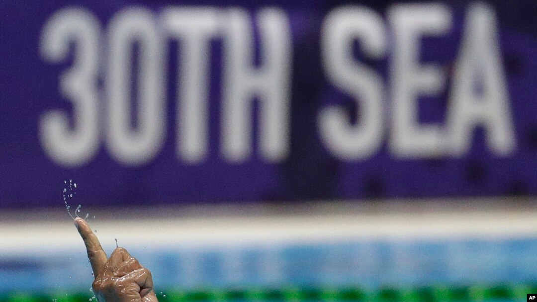 Philippines' Juan Paolo Serrano gestures after scoring a goal during their men's water polo match against Singapore at the 30th South East Asian Games in New Clark City, Tarlac province, Philippines, Nov. 29, 2019. 
