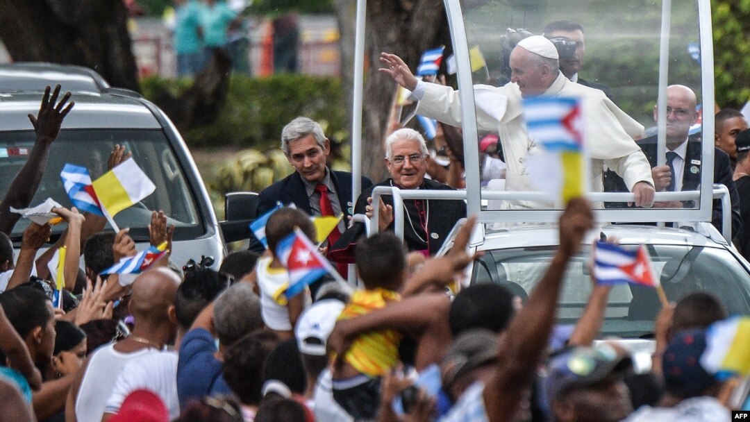 Pope Francis waves from the popemobile upon his arrival at El Cobre, Santiago de Cuba, to give a prayer at a basilica to Our Lady of Charity of El Cobre, the patron saint of Cuba, Sept. 21, 2015. 