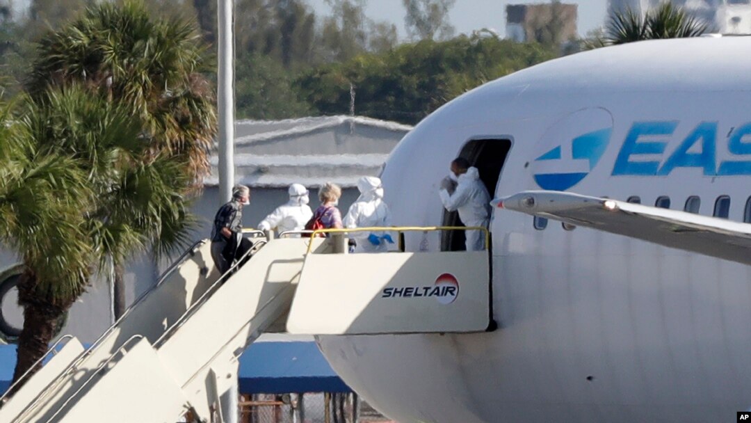 Passengers that came off the cruise ship Rotterdam, board a charter plane at Fort Lauderdale–Hollywood International Airport, April 3, 2020, in Fort Lauderdale, Fla.