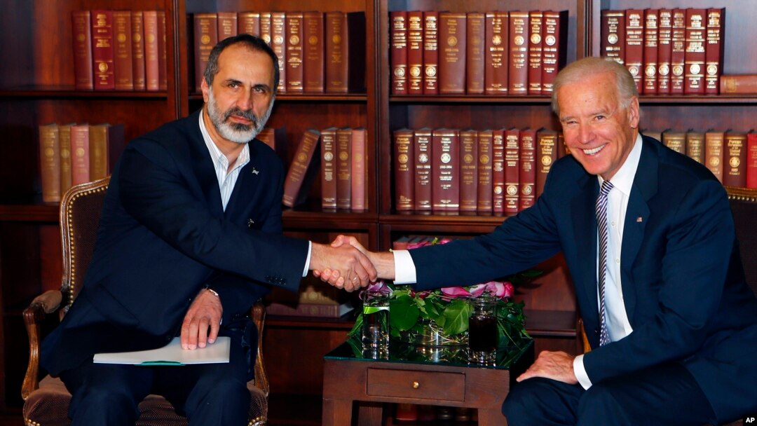 US Vice President Joe Biden, right, and Sheikh Moaz al-Khatib, Syria's top opposition leader, shake hands at the Security Conference in Munich, Germany, February 2, 2013.