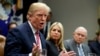 Florida Attorney General Pam Bondi, center, and Attorney General Jeff Sessions, right, watch as President Donald Trump speaks during a meeting with state and local officials to discuss school safety, in the Roosevelt Room of the White House, Feb. 22, 2018.