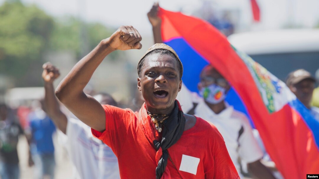 FILE - A man protesting the deportation of Haitian migrants by the United States marches toward the U.S. Embassy, in Port-au-Prince, Haiti, Sept. 26, 2021.