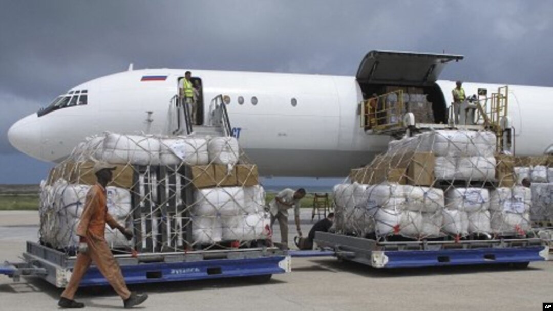 Tons of relief from the United Nations High Commissioner for Refugees (UNHCR) are offloaded after landing at Mogadishu airport, Somalia, Monday, Aug. 8, 2011