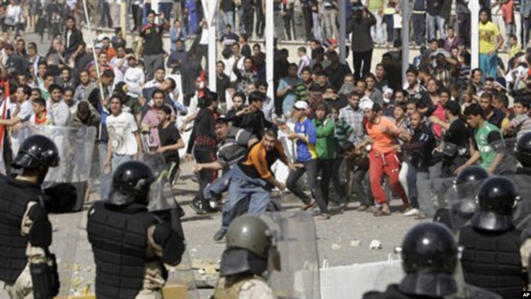 Iraqi riot police officers prevent anti-government protesters from entering the heavily guarded Green Zone during a demonstration in Baghdad, February 25, 2011