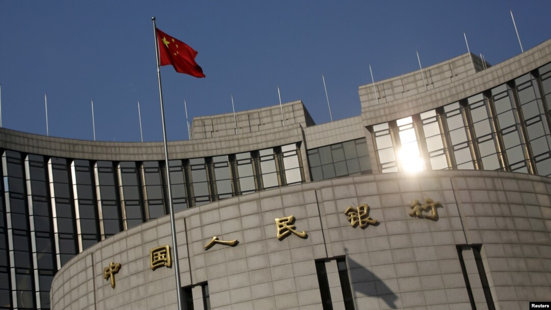 A Chinese national flag flies at the headquarters of the People's Bank of China, the country's central bank, in Beijing, Jan. 19, 2016. 