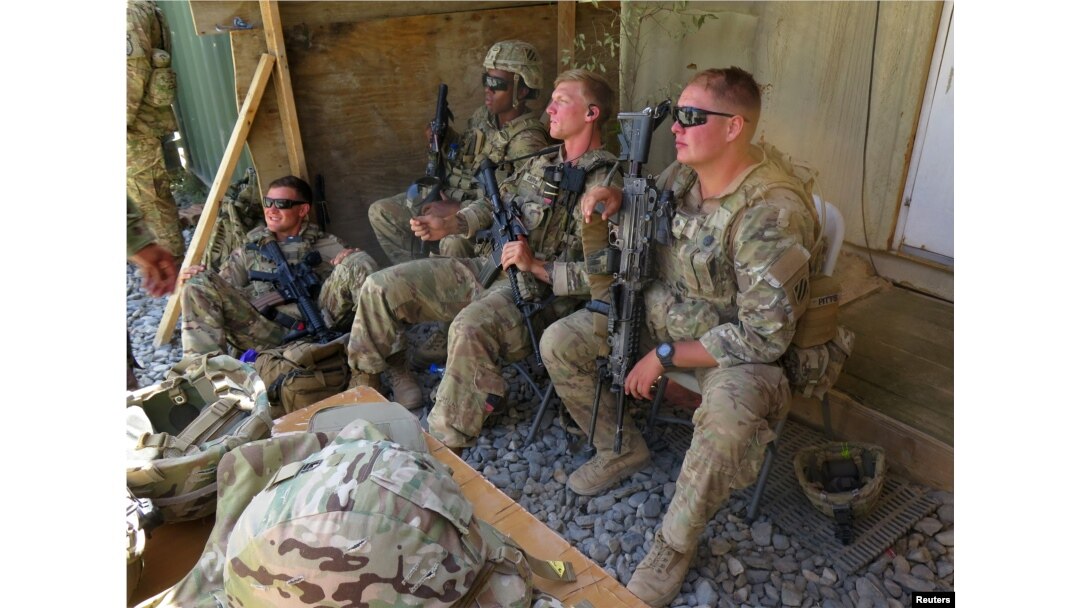 FILE - U.S. military advisers from the 1st Security Force Assistance Brigade sit at an Afghan National Army base in Maidan Wardak province, Afghanistan, Aug. 6, 2018.