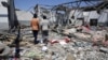 FILE - Debris covers the ground after an airstrike at a detention center in Tajoura, east of Tripoli in Libya, July 3, 2019. 