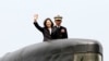 FILE - Taiwan's President Tsai Ing-wen, left, waves from a Zwaardvis-class submarine during a visit at Zuoying Naval base in Kaohsiung, southern Taiwan, March 21, 2017.