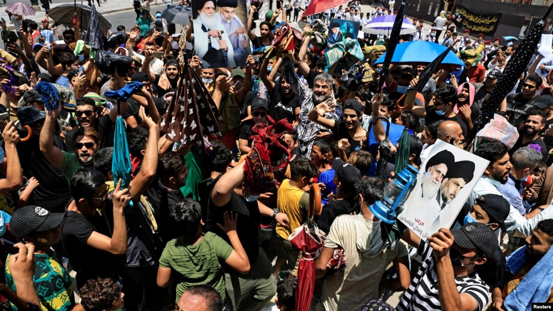 Supporters of Iraqi Shi'ite Muslim cleric Muqtada al-Sadr shout slogans during a protest over frequent electricity cuts after Friday prayers in Baghdad's Sadr City, Iraq, July 2, 2021.