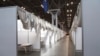 In this March 27, 2020 photo provided by Office of Governor Andrew M. Cuomo, makeshift hospital rooms stretch out along the floor at the Jacob Javits Convention Center in New York.