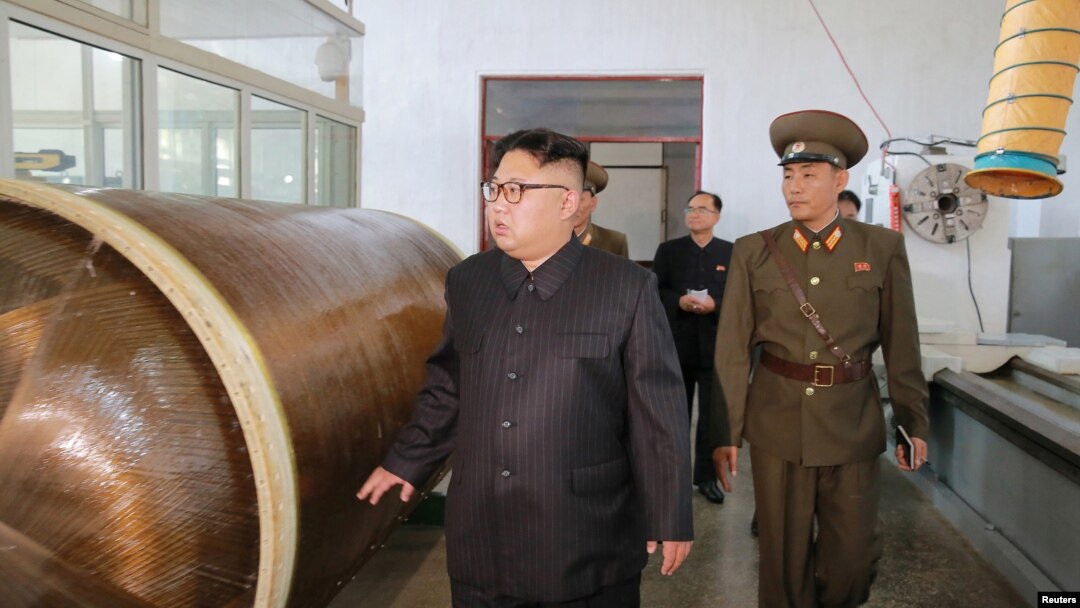 지난해 8월 북한의 김정은 국무위원장이 국방과학원 화학재료연구소 시찰 사진에 갈색의 원통 물체 옆에 서 있다. 