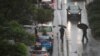 Pedestrians brave strong wind and rain in Sydney, New South Wales, Australia, Feb. 9, 2020. 