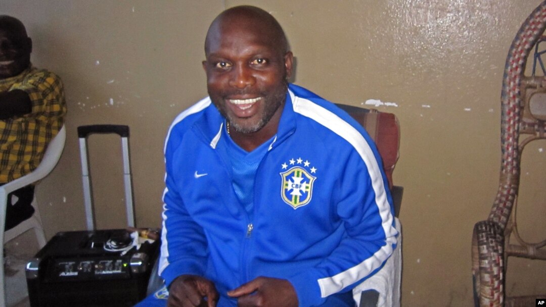 FILE - Liberian soccer star George Weah smiles inside a room in Monrovia, Liberia, Aug. 10, 2014. 