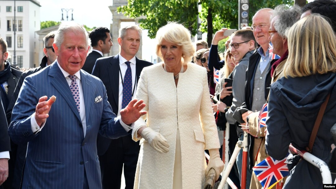Britain's Prince Charles, Prince of Wales and his wife Britain's Camilla, Duchess of Cornwall greet the crowd during a visit at the Brandenburg Gate in Berlin, Germany, May 7, 2019.