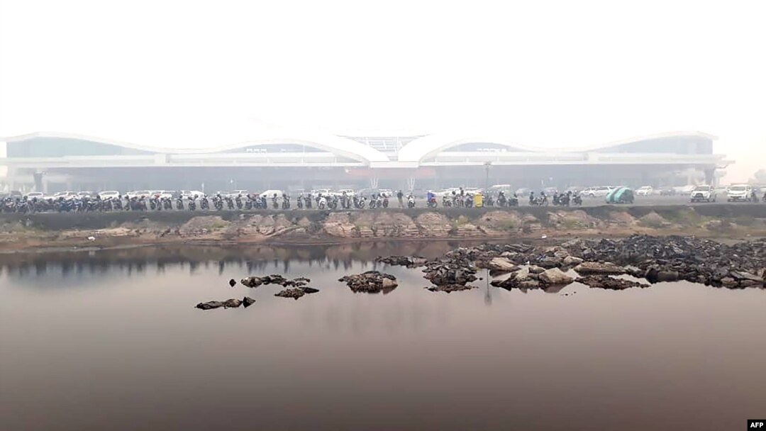 FILE - Haze covers the airport in Palangkaraya, central Kalimantan, Indonesia, Sept. 16, 2019. An American journalist was detained in Palangkaraya in December, and later formally arrested, for alleged visa violations.