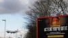 FILE - A plane comes in to land near a government coronavirus sign at Heathrow Airport in London, Britain, Feb. 5, 2021.