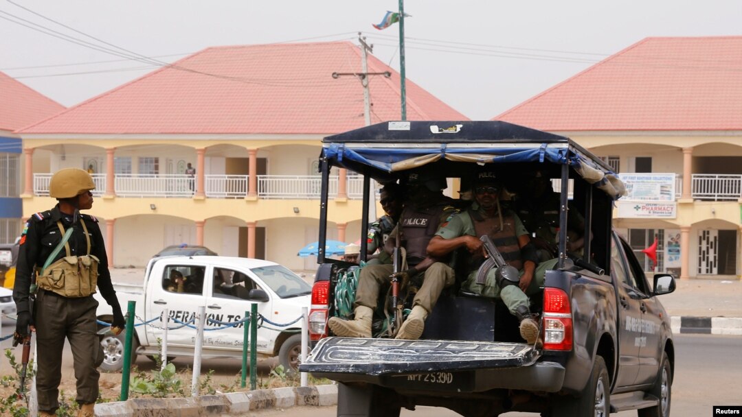 FILE - A police vehicle drives through Yola, in Adamawa state, Nigeria, Feb. 15, 2019. A Nigerian reporter has died after being found Jan. 15, 2020, bound and gagged in a farmer's field in the area.