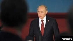 Russia's President Vladimir Putin speaks to journalists after meetings in Shanghai May 21, 2014.