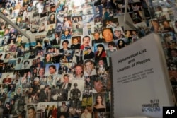 FILE - Photographs of some of those who died during the terrorist attacks on the World Trade Center, the Pentagon, and Shanksville, Pennsylvania, are on display at the 9/11 Tribute Museum in New York, June 8, 2017.