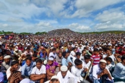 FILE - Rohingya refugees attend a ceremony to mark the second anniversary of the exodus at the Kutupalong refugee camp in Ukhia, Aug. 25, 2019.