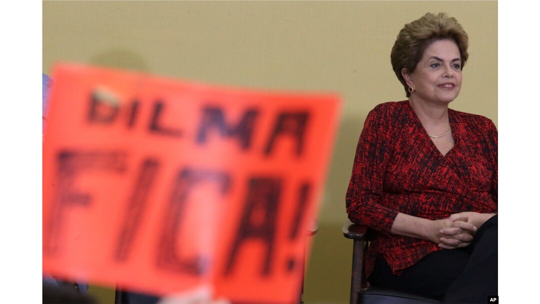 Brazil’s President Dilma Rousseff attends having in front a poster written in Portuguese "Dilma Stay, during ceremony of the Launch Program New Federal Universities, at the Planalto Presidential Palace, in Brasilia, May 9, 2016.