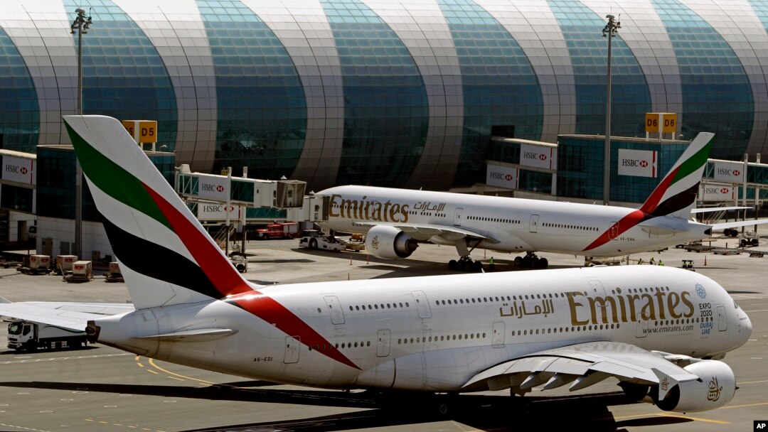 FILE - This May 8, 2014 file photo shows Emirates passenger planes at Dubai airport in United Arab Emirates. The U.S. government is temporarily barring passengers on certain flights originating in eight other countries from bringing most types of electronics in their carry-on luggage. (AP Photo/Kamran Jebreili, File)