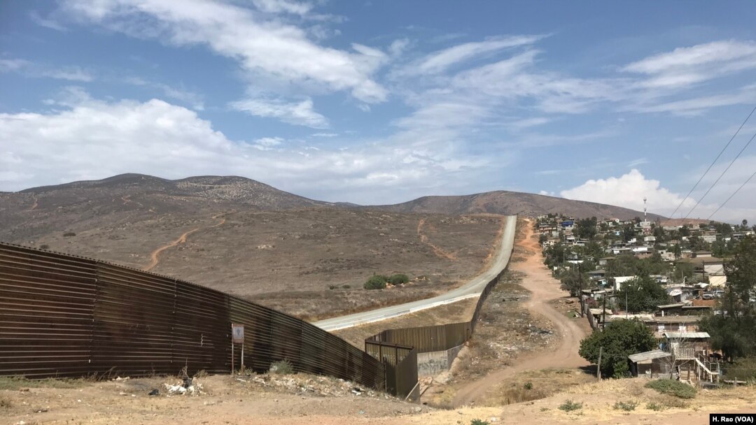 A fence runs along the U.S.-Mexico border.