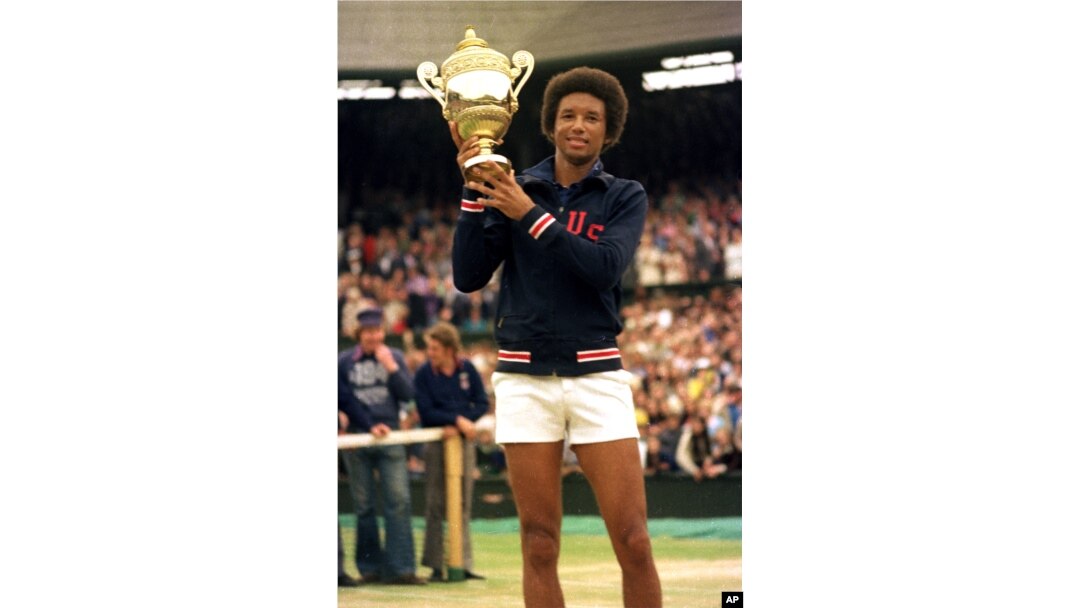 Arthur Ashe holds his Wimbledon trophy cup after defeating fellow American Jimmy Connors in the final match of the men's singles championship at the All England Lawn Tennis Championship in Wimbledon, England, July 5, 1975.