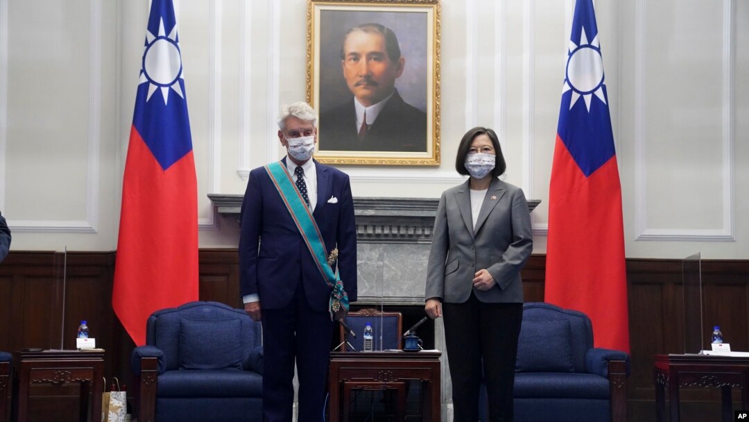 FILE - Taiwanese President Tsai Ing-wen, right poses for a photo after awarding a medal of honor to Alain Richard, the head of the French Senate's Taiwan Friendship Group, at the Presidential Office in Taipei, Taiwan, Oct. 7, 2021.