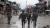 Government troops pass destroyed buildings and houses in Datu Sa Dansalan in Marawi city, southern Philippines, Oct. 17, 2017.