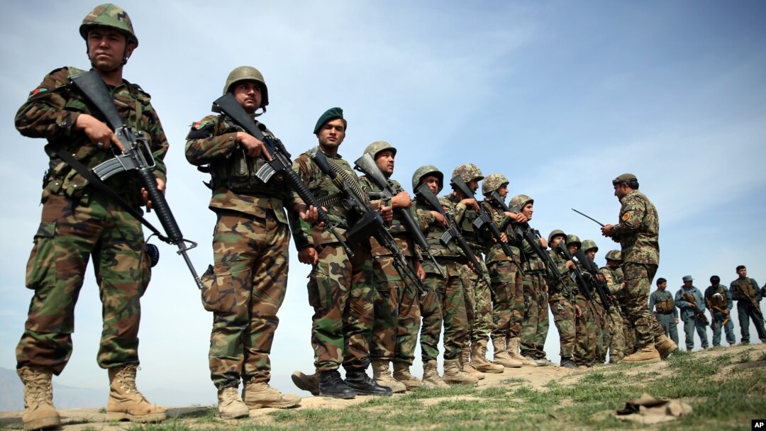 FILE - Afghan National Army soldiers stand in formation following weeks of heavy clashes with Taliban fighters in Dahna-e-Ghori district, Baghlan province, Afghanistan, Mar. 15, 2016.