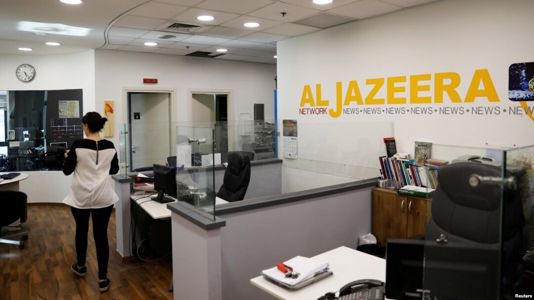 FILE: An employee walks inside an office of Qatar-based Al Jazeera network in Jerusalem, June 13, 2017. 