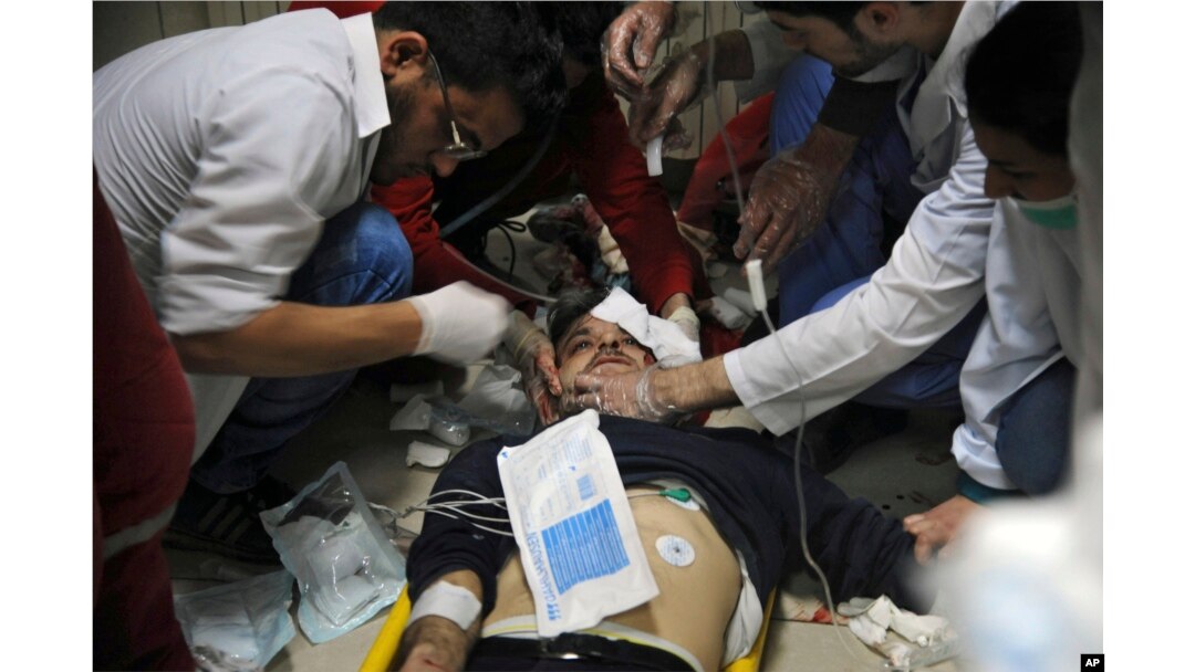 This photo released by the Syrian official news agency SANA shows a man receiving treatment at a hospital in Damascus, Syria, April. 7, 2018. State TV said Army of Islam fighters pelted several neighborhoods in Damascus with mortar shells, killing six civilians and wounding more than 30.