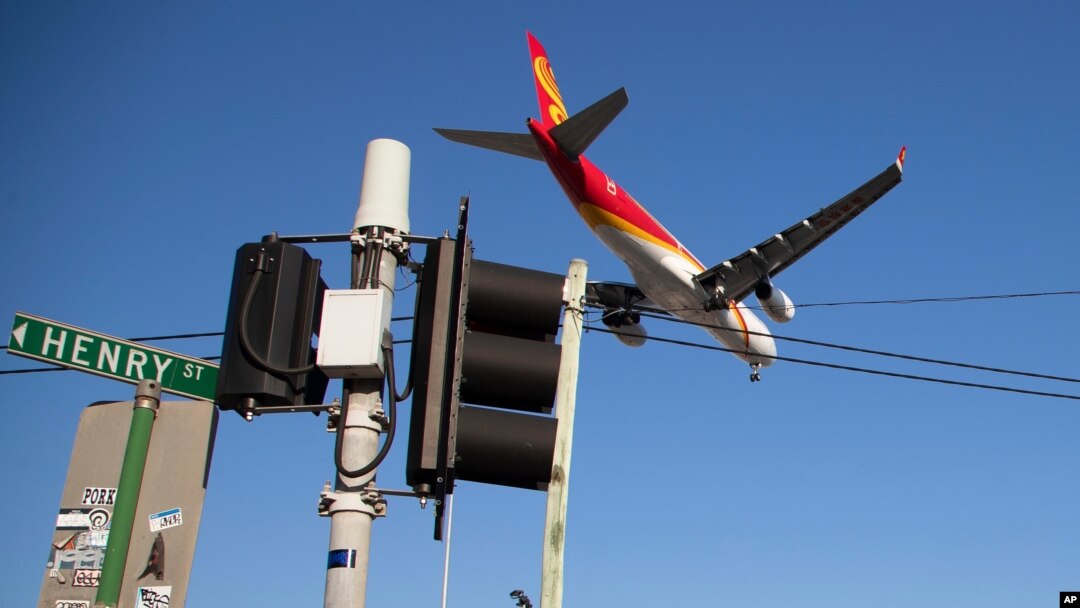 FILE - A passenger jet makes its final approach for landing into Sydney Airport, Apr. 26, 2021.