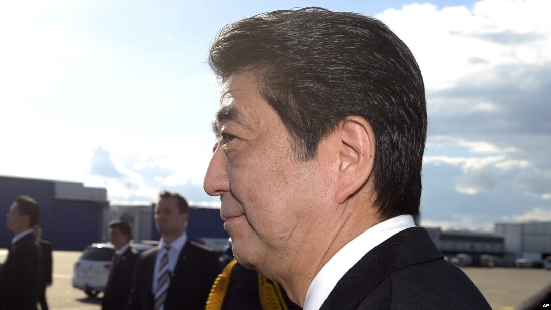 Japanese Prime Minister Shinzo Abe, foreground and his wife, Akie, arrive at the Helsinki International Airport in Vantaa, Finland, July 9, 2017. 