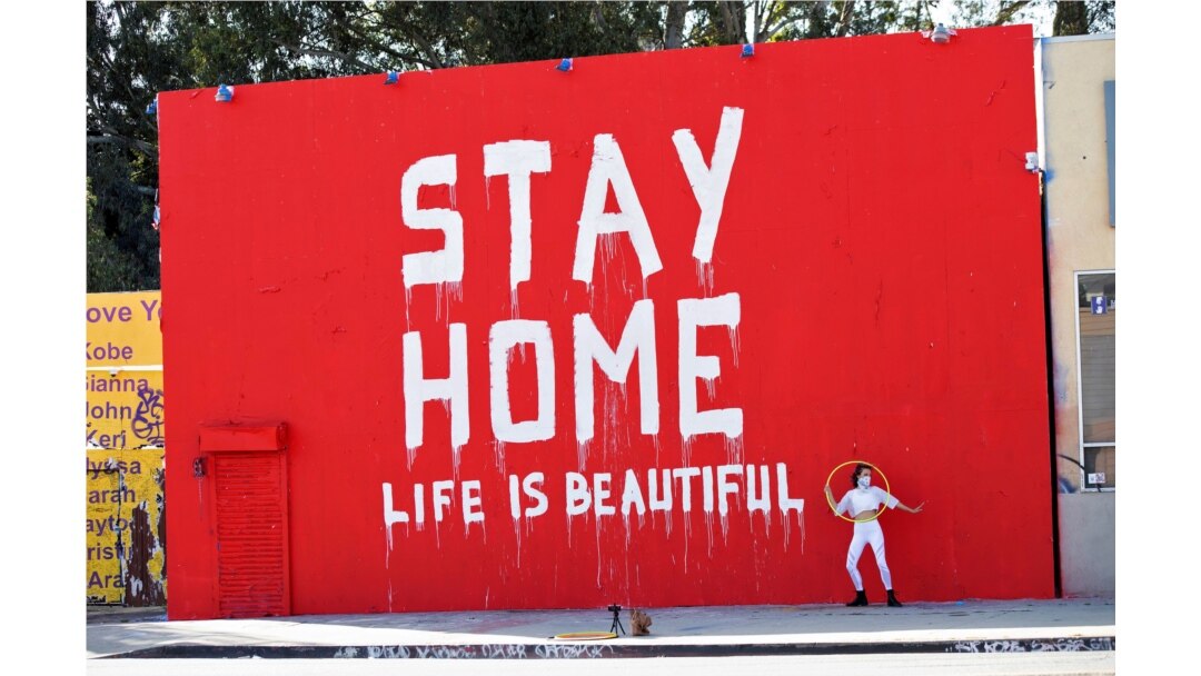 Dance instructor Morgan Jenkins makes a video in front of a mural amid the global outbreak of the coronavirus disease in Los Angeles, California, U.S., on April 3, 2020.
