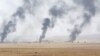 FILE - Smoke rises in the aftermath of clashes with Islamic State militants on the southeast of Mosul, Iraq, Aug. 14, 2016.