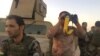 Kurdish Peshmerga soldiers observe the ongoing battle on Oct. 20, 2017, in Altun Kobri, a disputed area of northern Iraq. (H.Murdock/VOA)